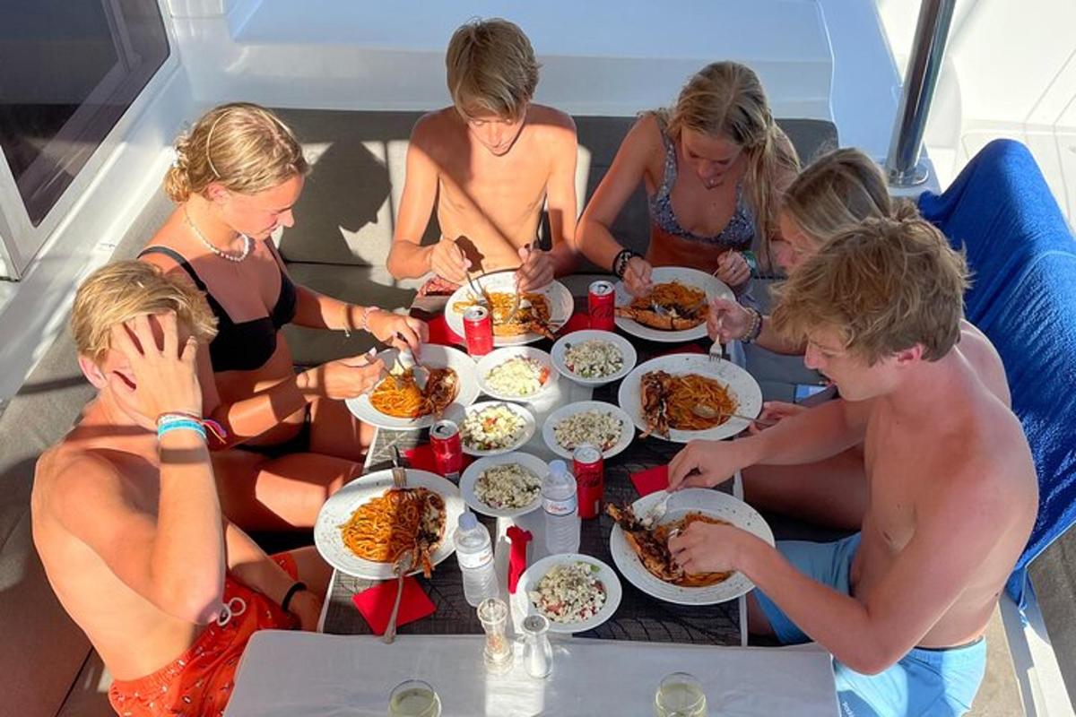a group of people sitting around a table eating food