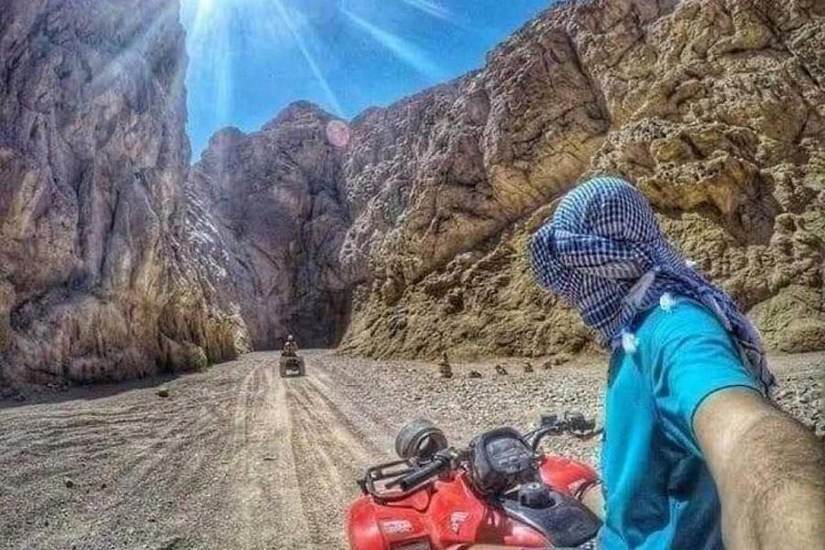 a person riding a motorcycle on a dirt road