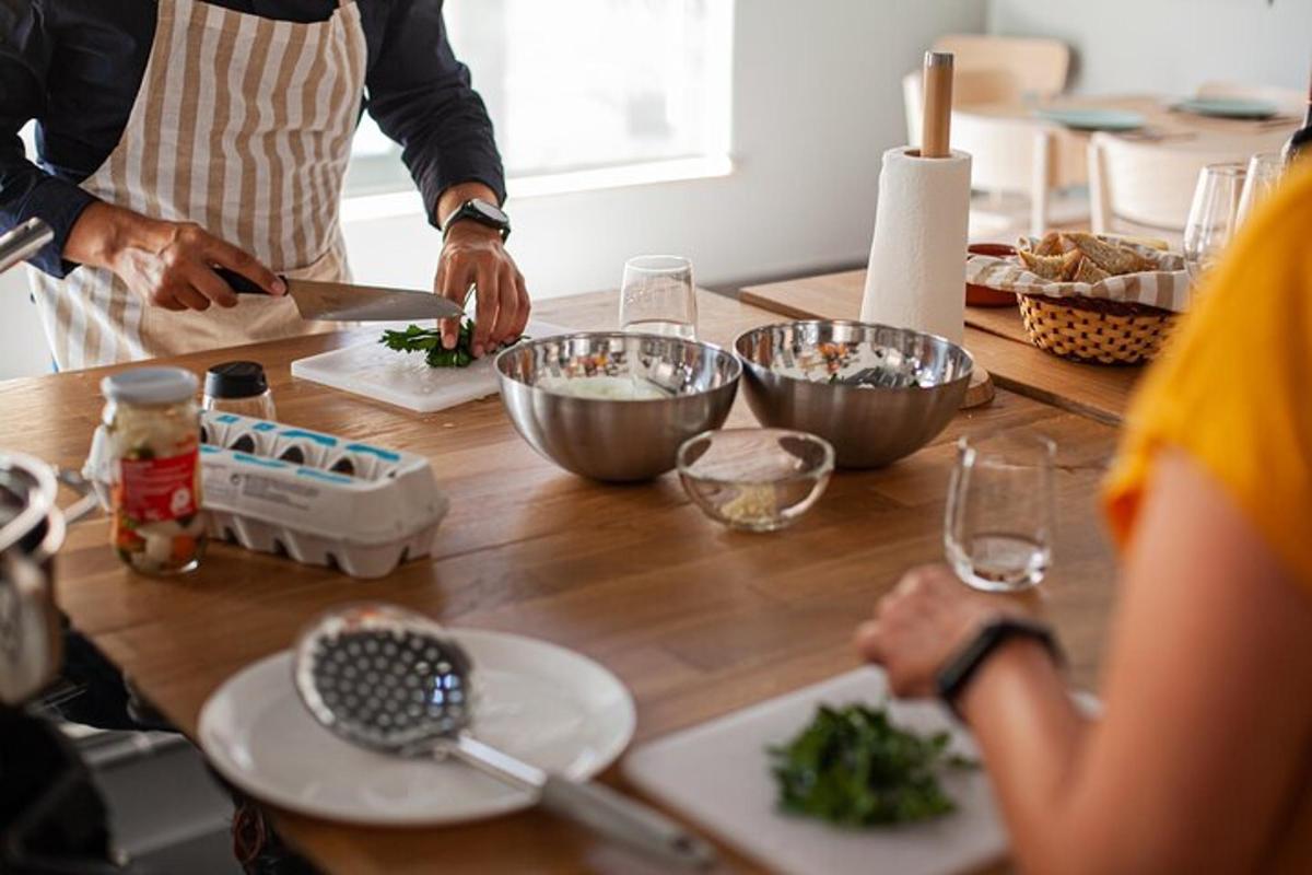 a group of people standing around a table preparing food