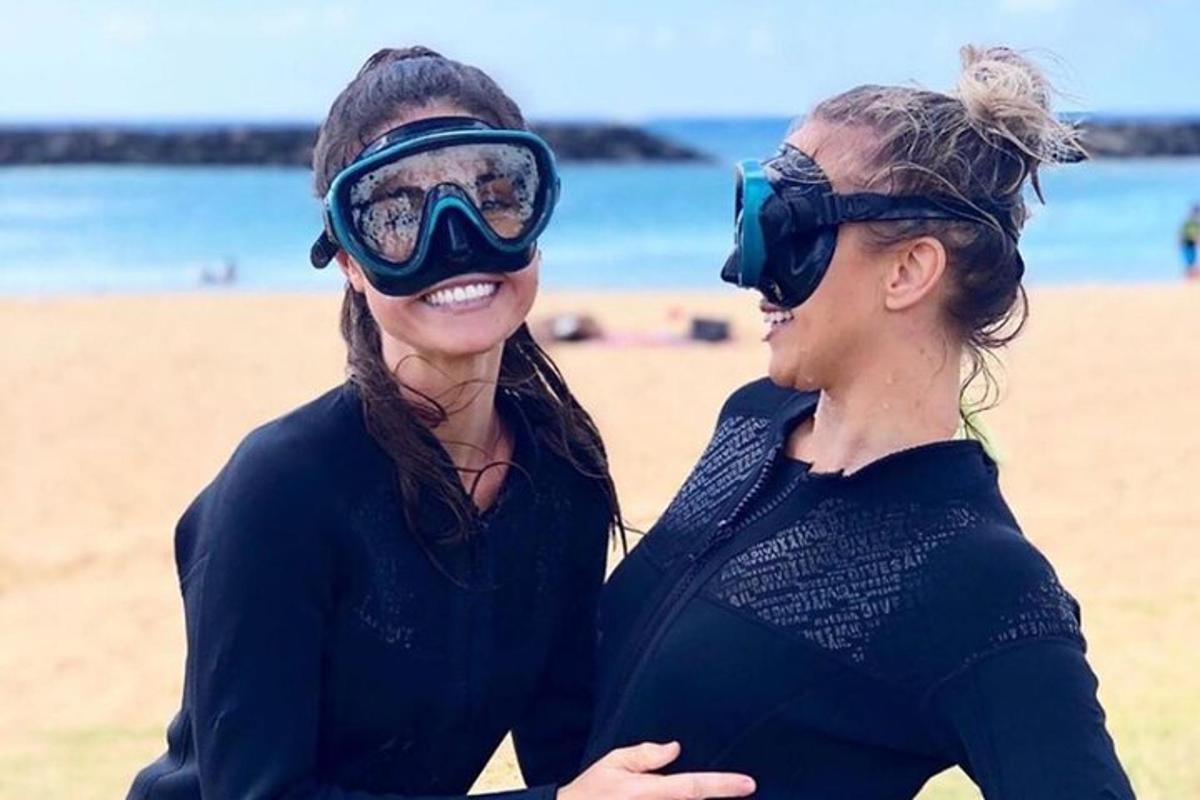 due donne in piedi una accanto all'altra su una spiaggia
