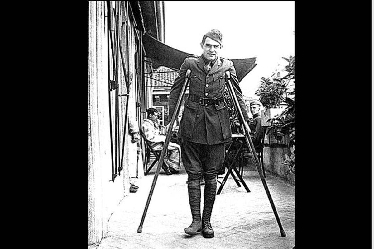 a man in uniform standing in front of a building