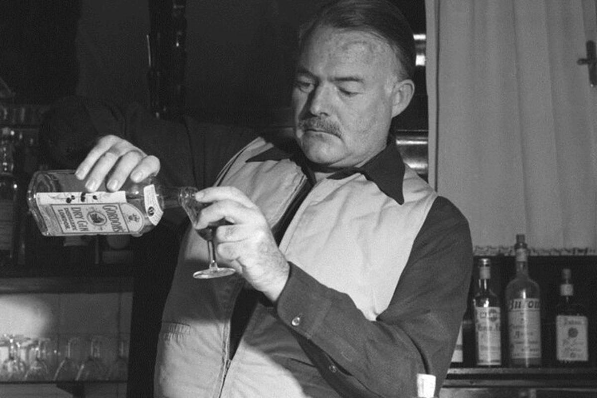 a man is holding a glass of wine