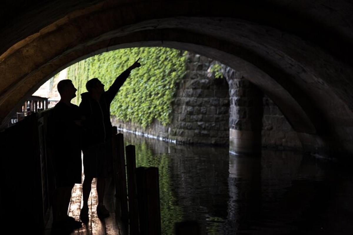 zwei Personen stehen mit erhobenen Armen unter einem Tunnel