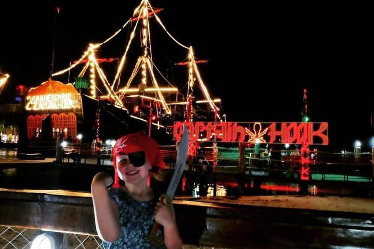 a woman standing in front of a carnival at night