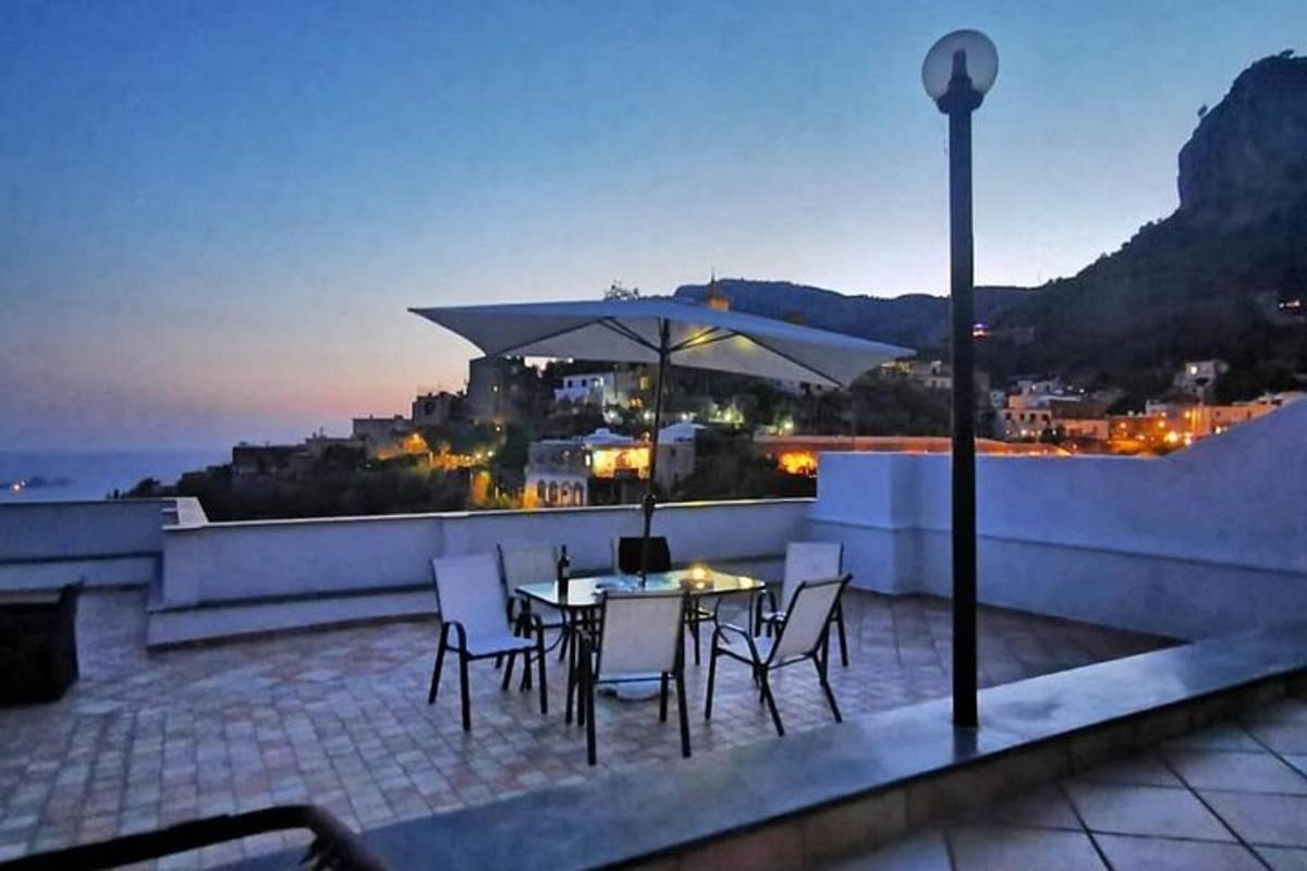 a patio with a table and chairs and an umbrella