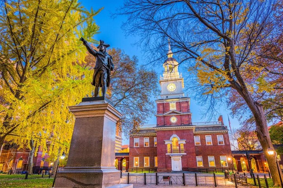 a statue in front of a building with a clock tower
