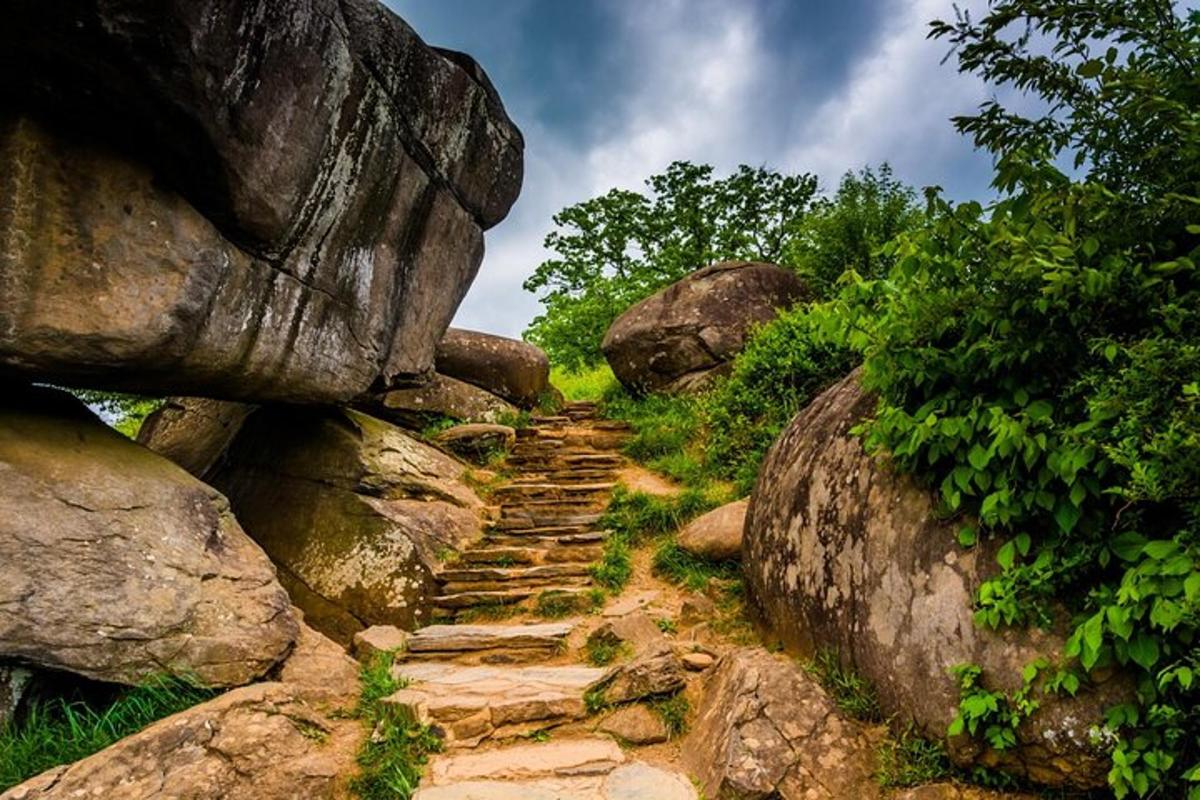 a stone path between rocks on a mountain