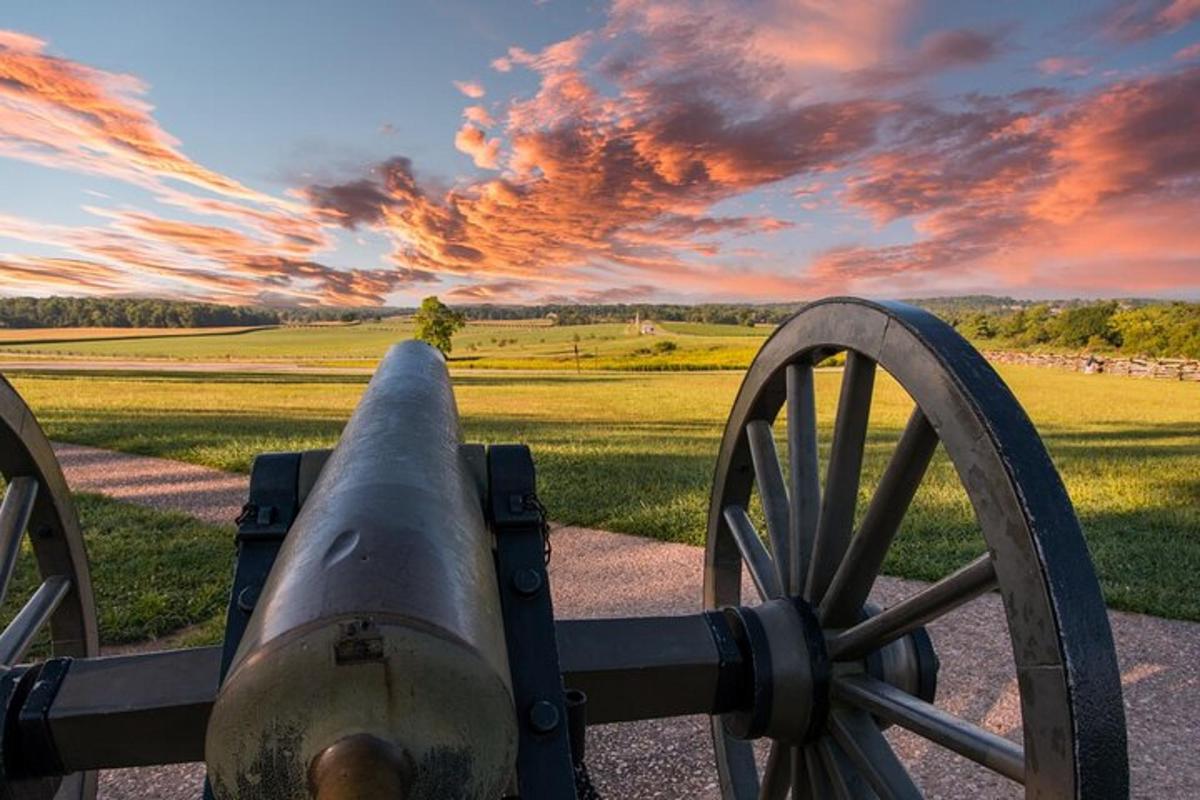 a cannon with a sunset in the background