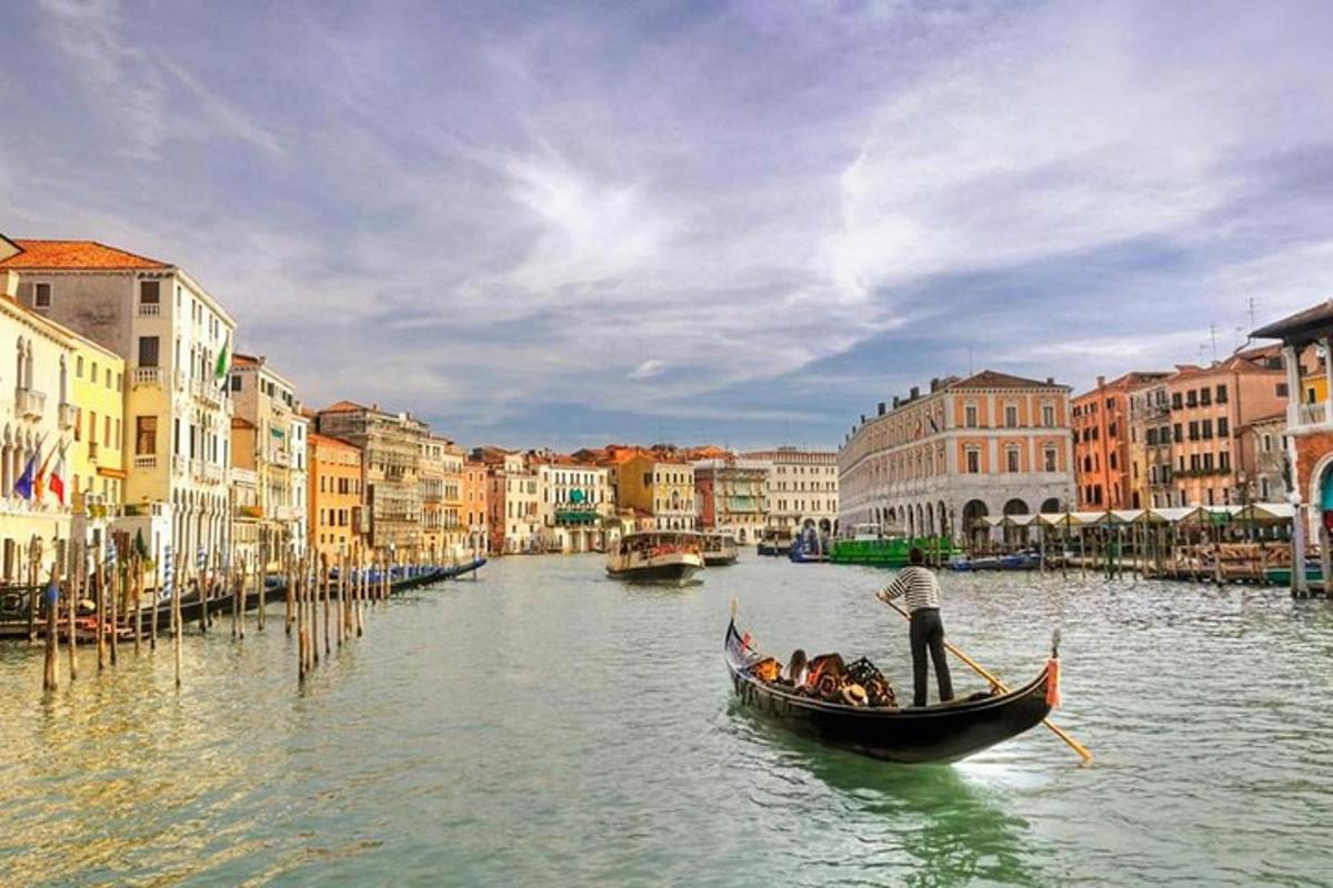 a group of people in a gondola on a canal