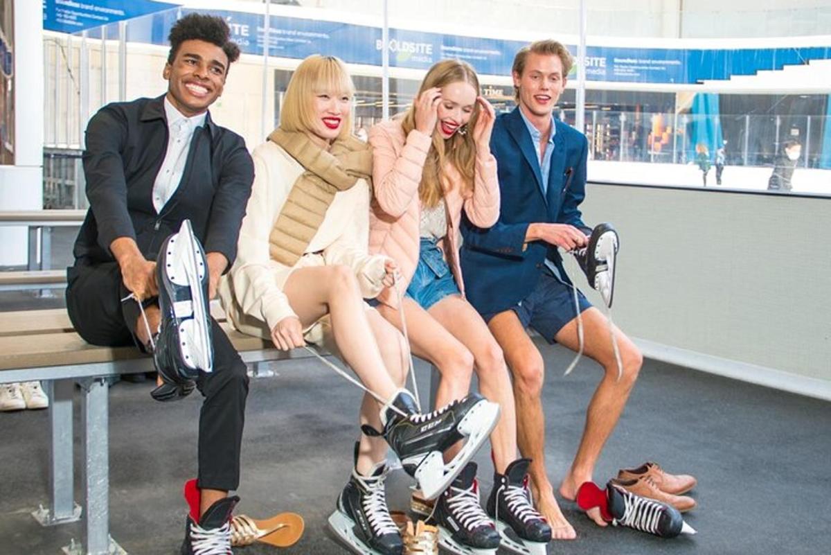a group of people sitting on a bench with their shoes