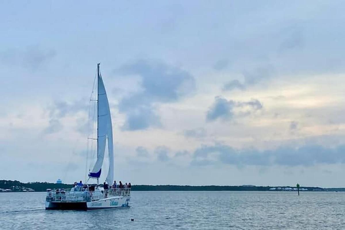 a boat with a large sail in the water