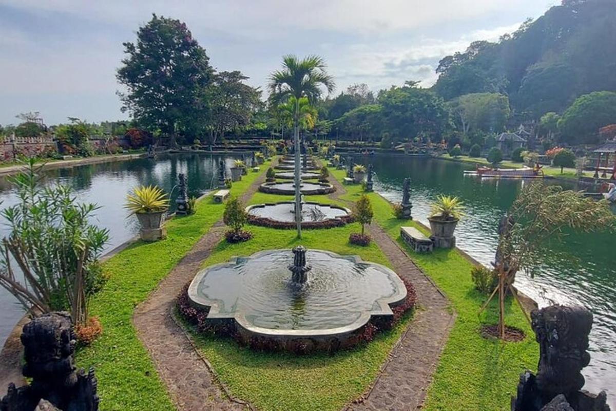 a fountain in a park next to a lake