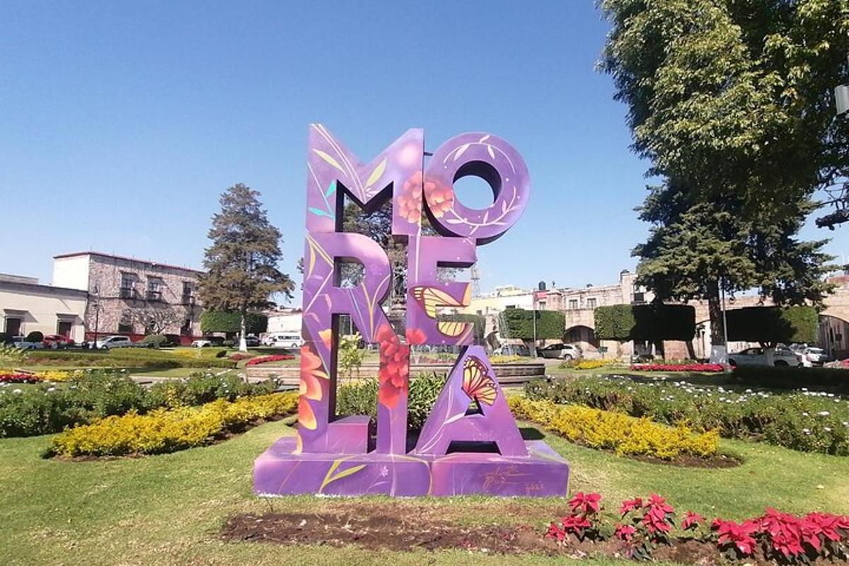 a large purple sign in the middle of a park