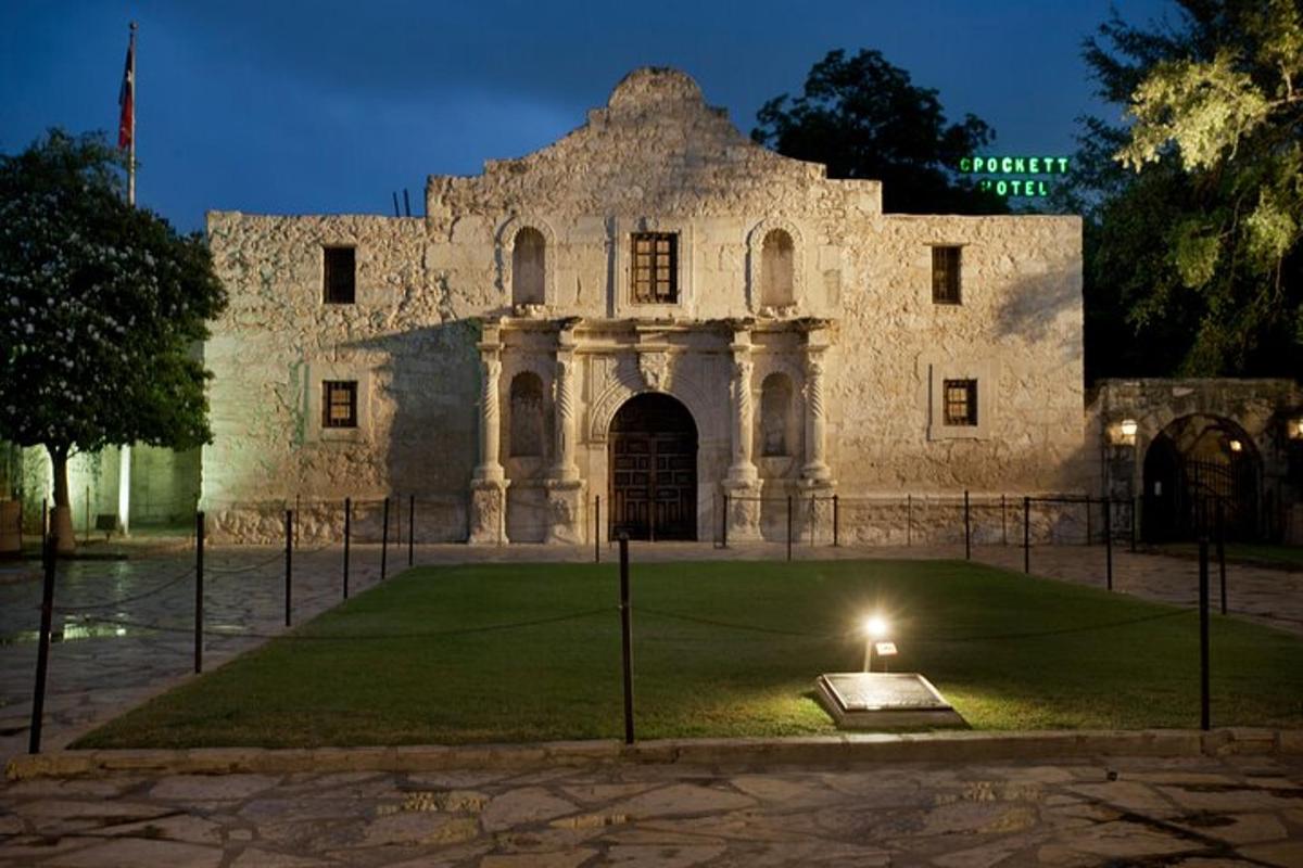 a building with a lawn in front of it at night