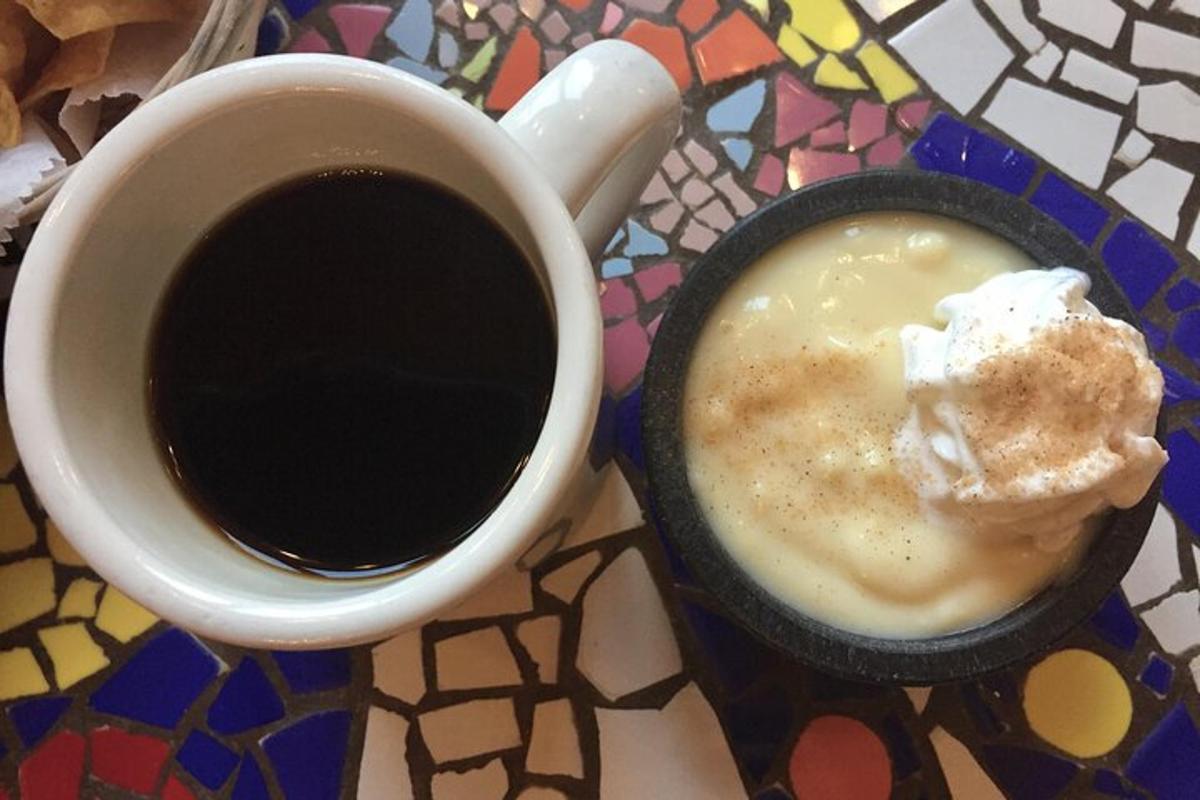 a cup of coffee sitting next to a cup of coffee