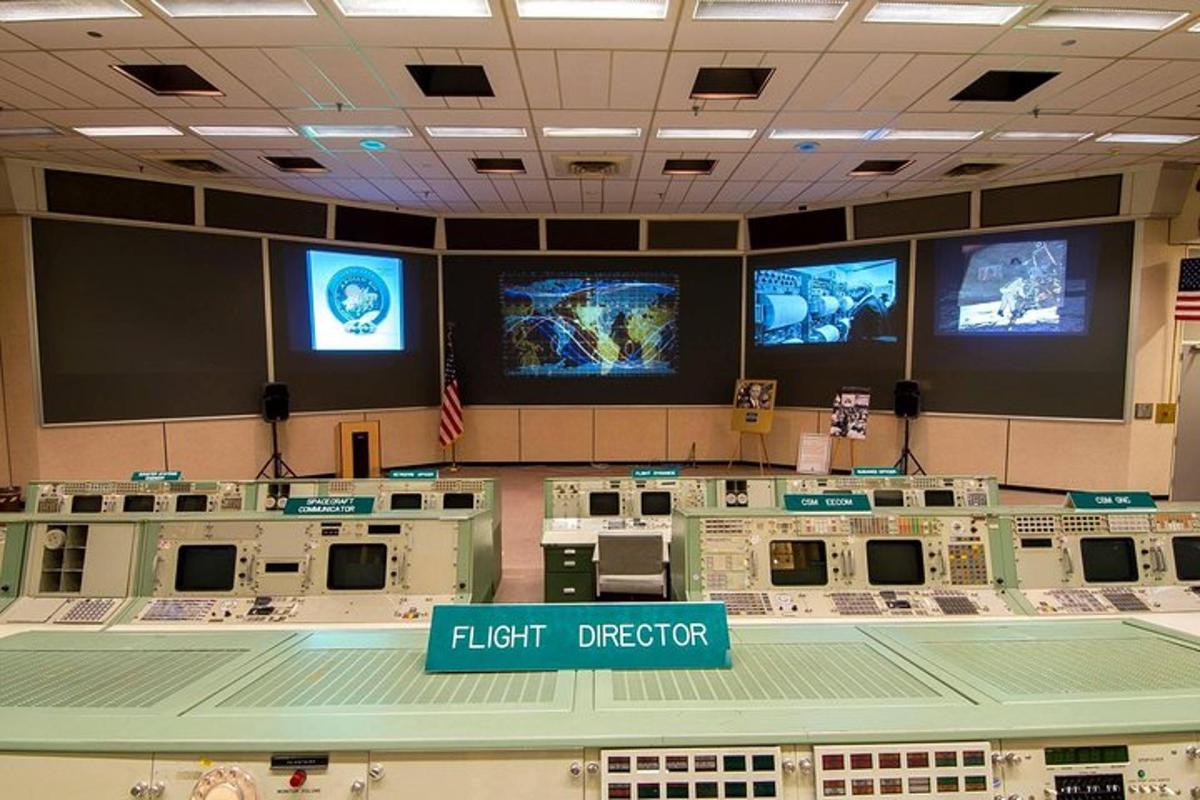 a large room with a lot of monitors on the wall