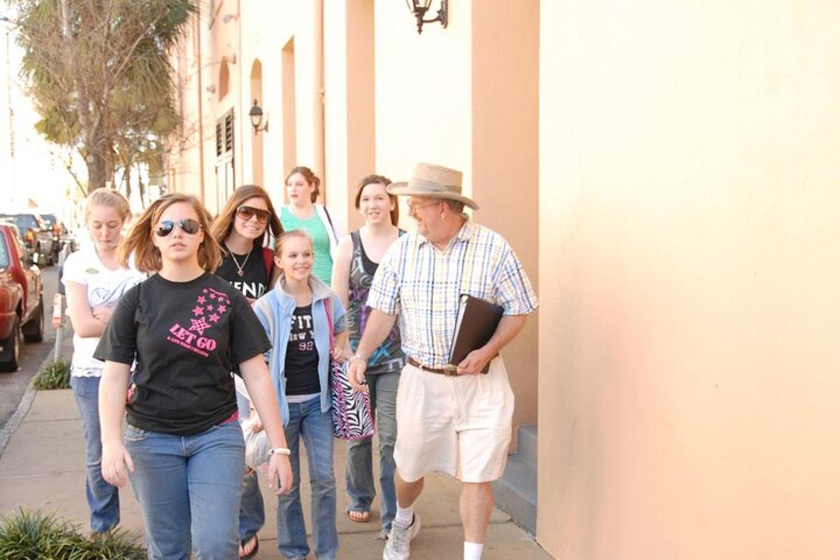 a group of people walking down a sidewalk