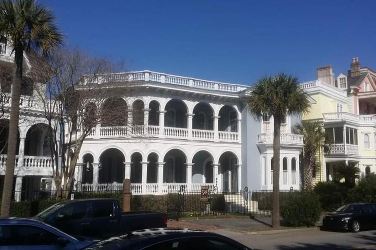 a large white house with palm trees in front of it