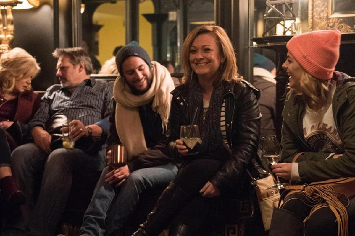 a group of people sitting on a bus with wine glasses