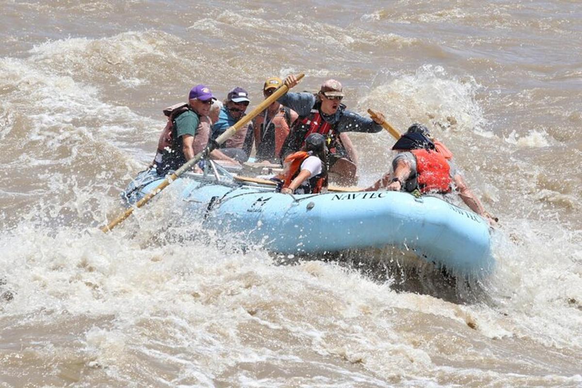 a group of people in a raft in the water