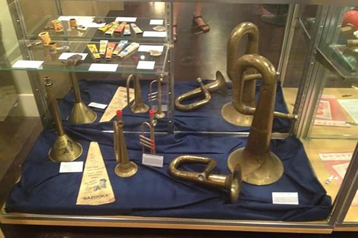 a display in a glass case with old weapons