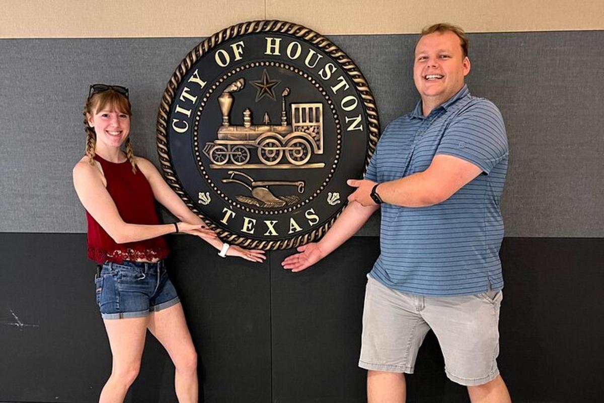 a man and a woman standing in front of a sign