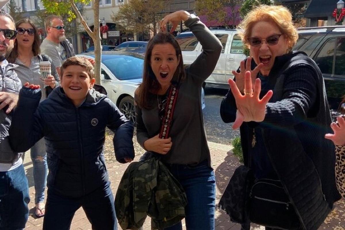 a group of people walking down a street with their hands up