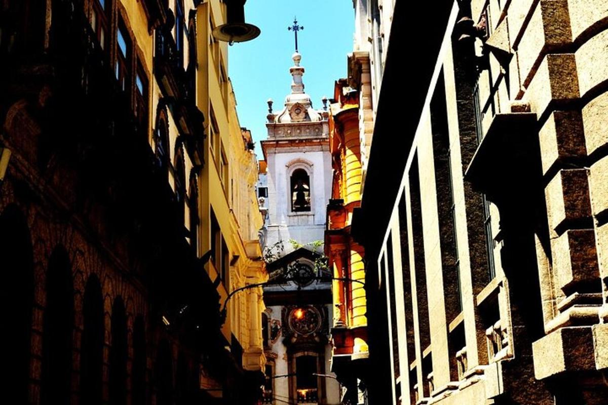 a building with a clock tower in the middle of a street
