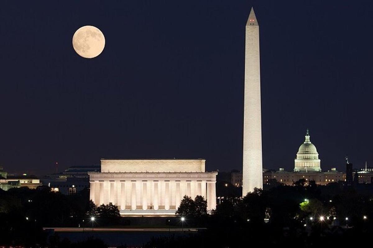 a full moon rises over the washington monument and the washington obelisk
