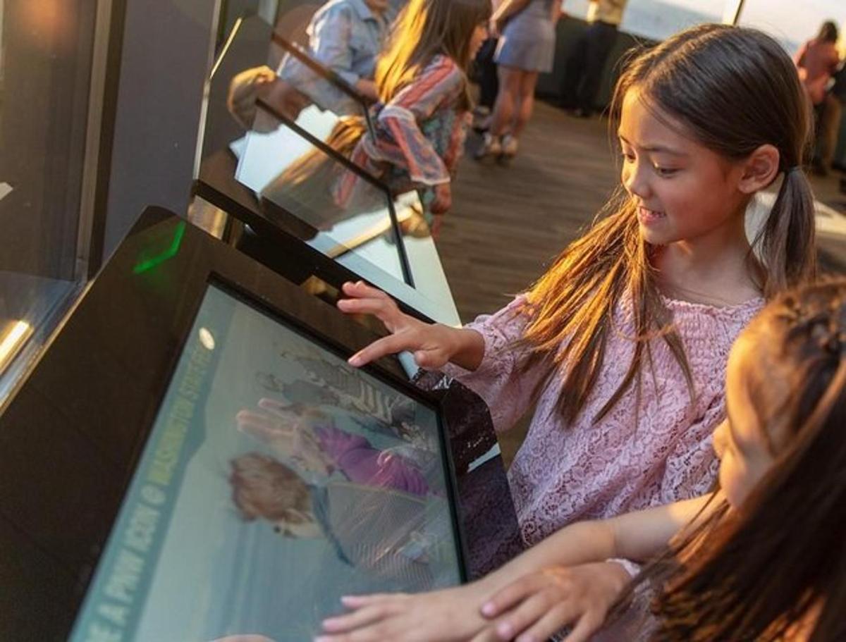 a little girl looking at a display in a museum
