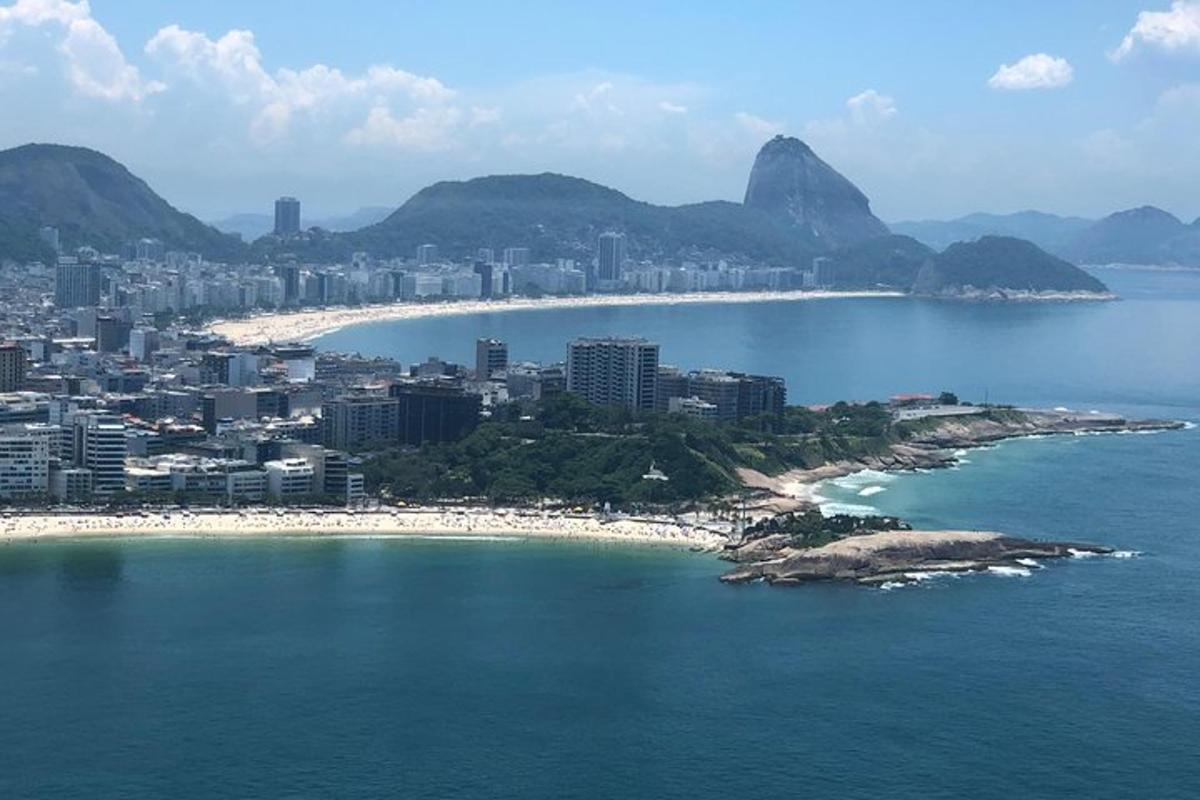 a view of a beach with a city and mountains