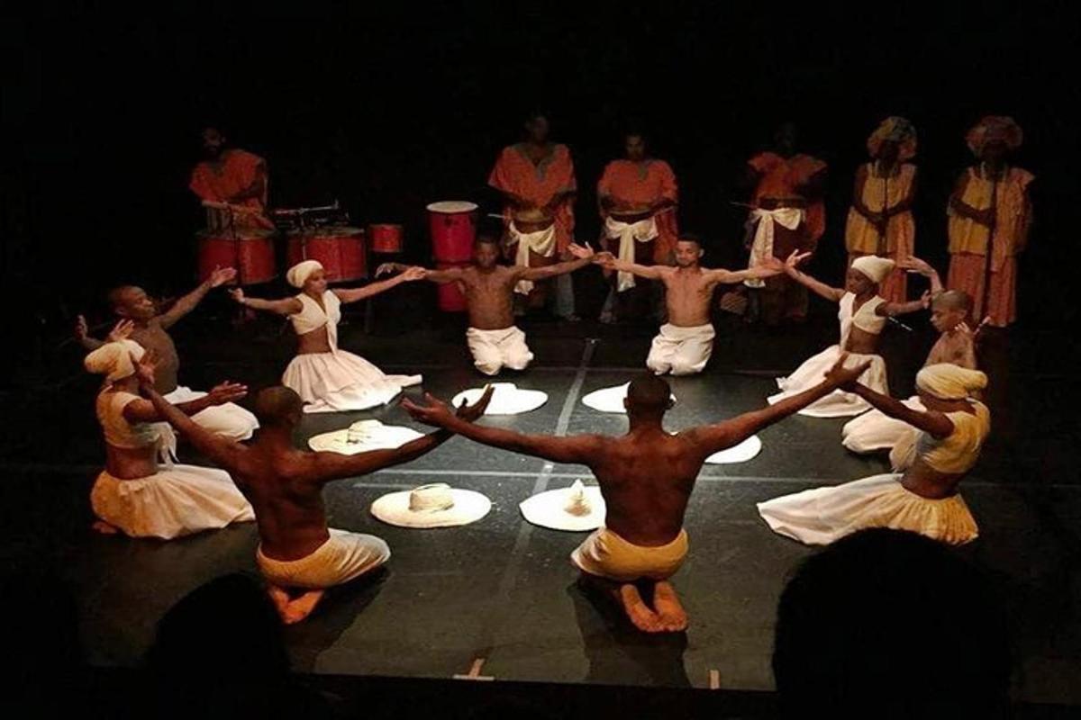 a group of men and women dancing on a stage