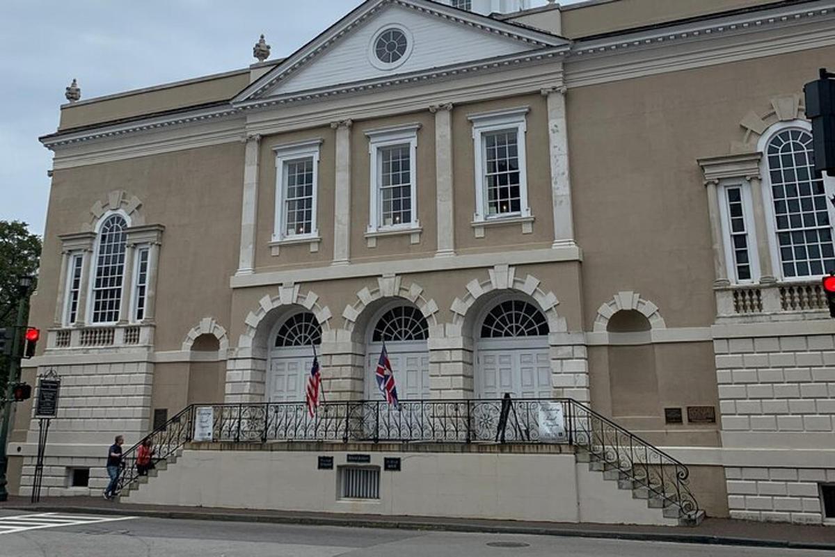 a large building with two flags on a balcony