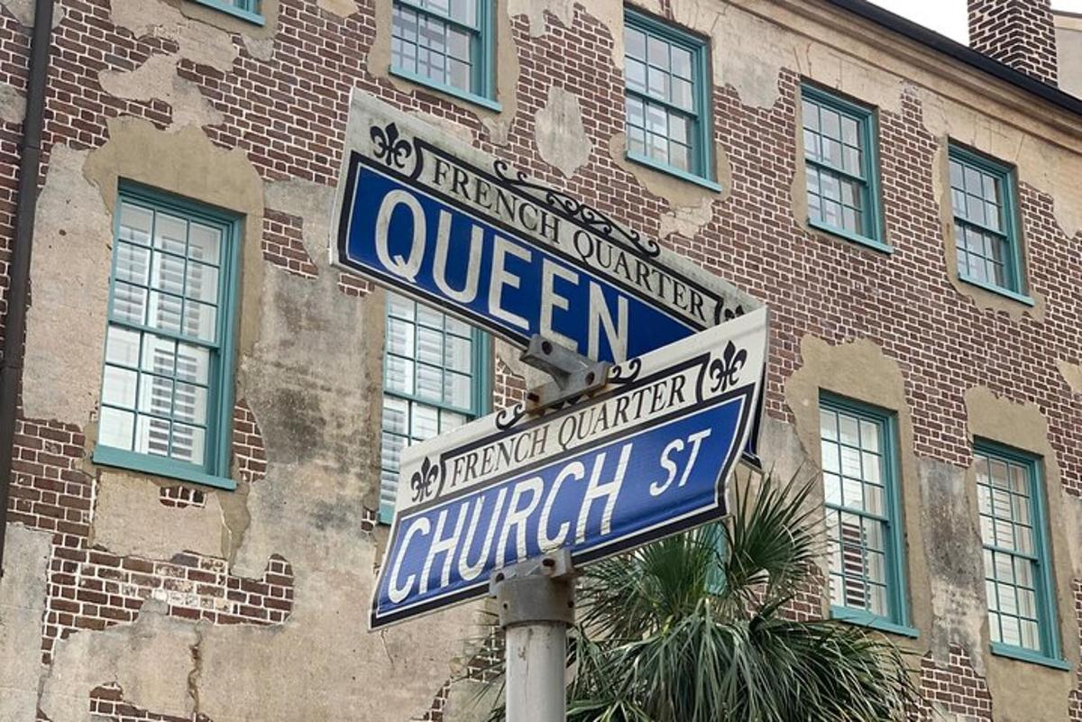 two street signs on a pole in front of a building