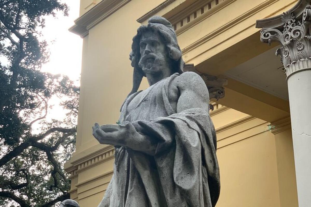 a statue of a man standing in front of a building