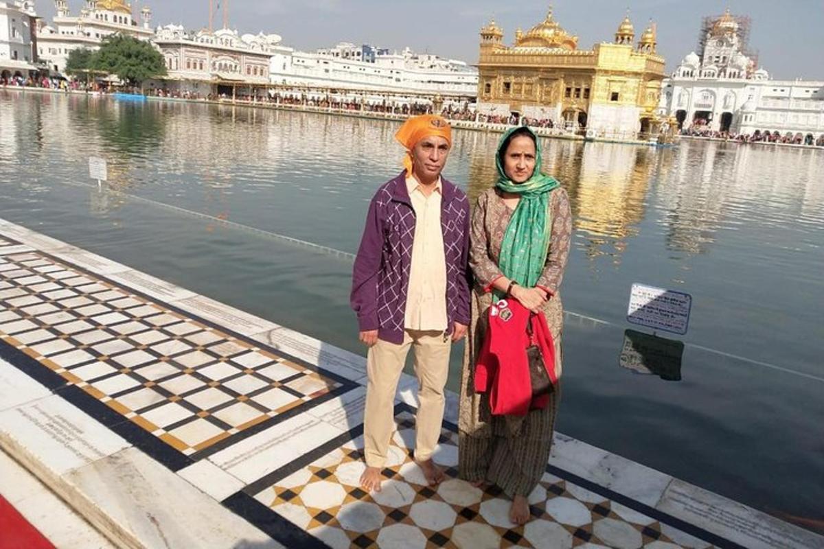 a man and a woman standing in front of a temple