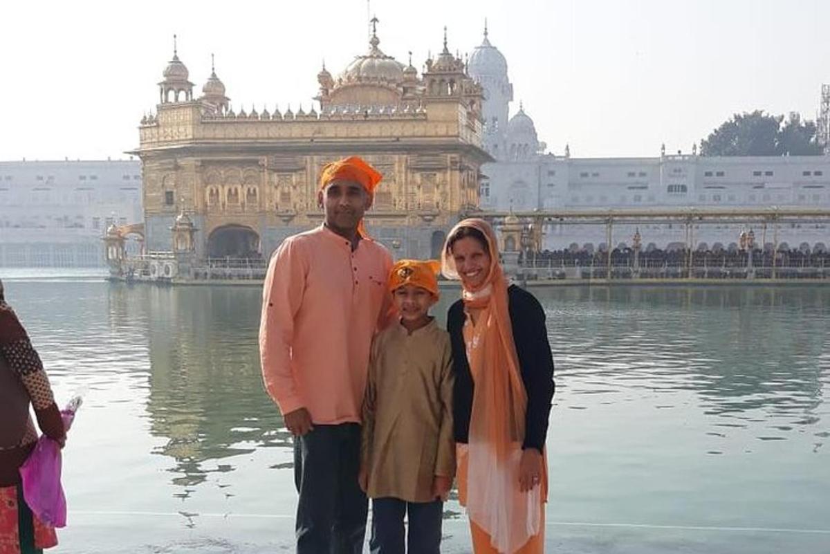 a family standing in the water in front of a building