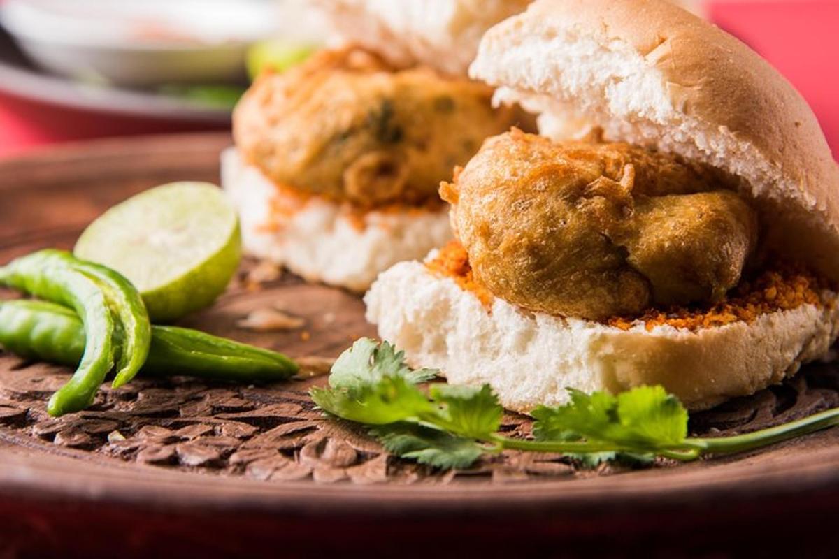 a plate with two chicken sub sandwiches and a pickle
