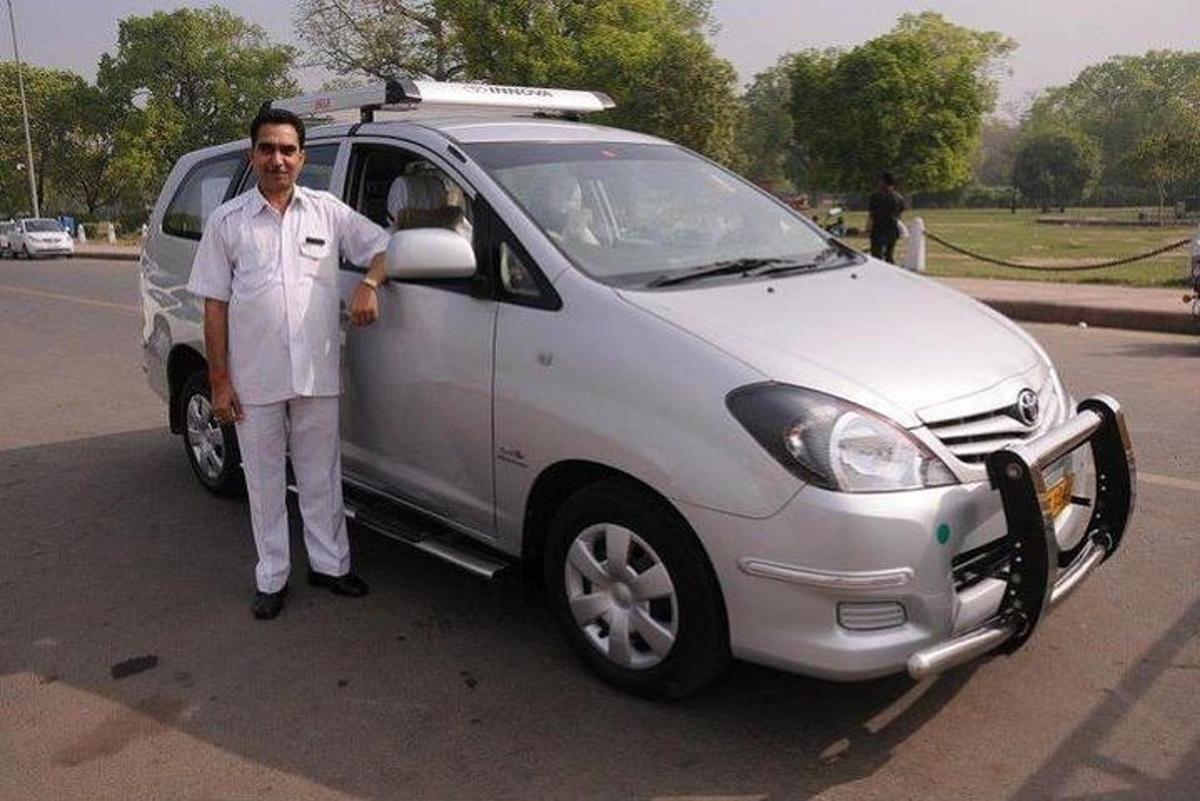 a man is standing next to a white car