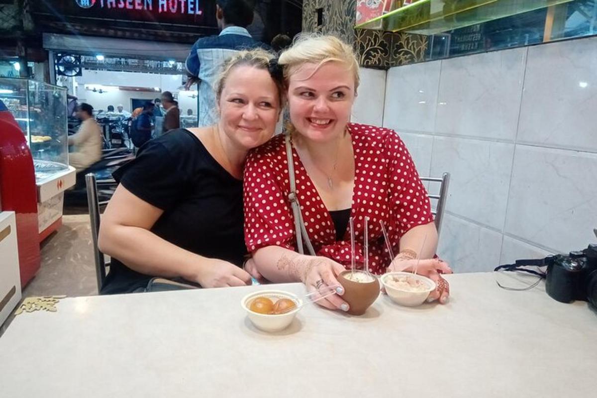 two women sitting at a table in a restaurant