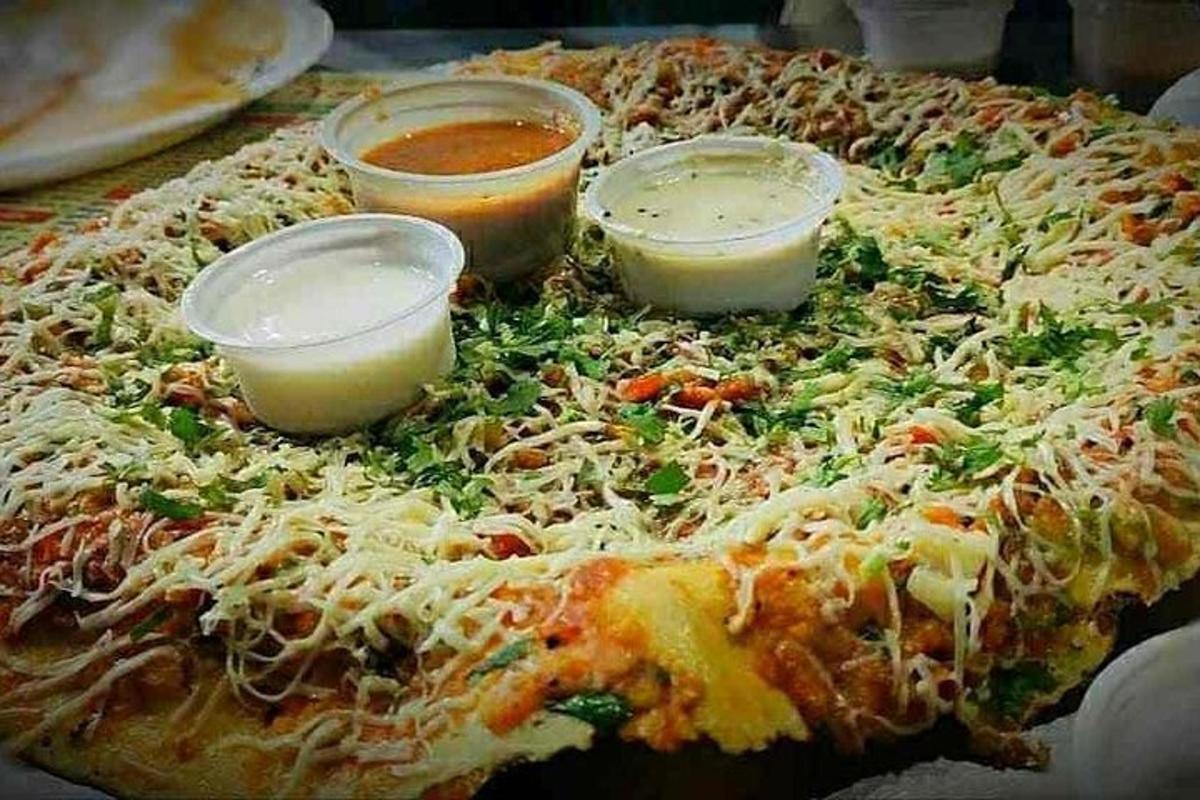 a pizza with three dipping sauces on top of it