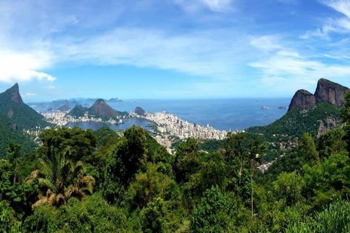 a view of the mountains with the ocean and a city