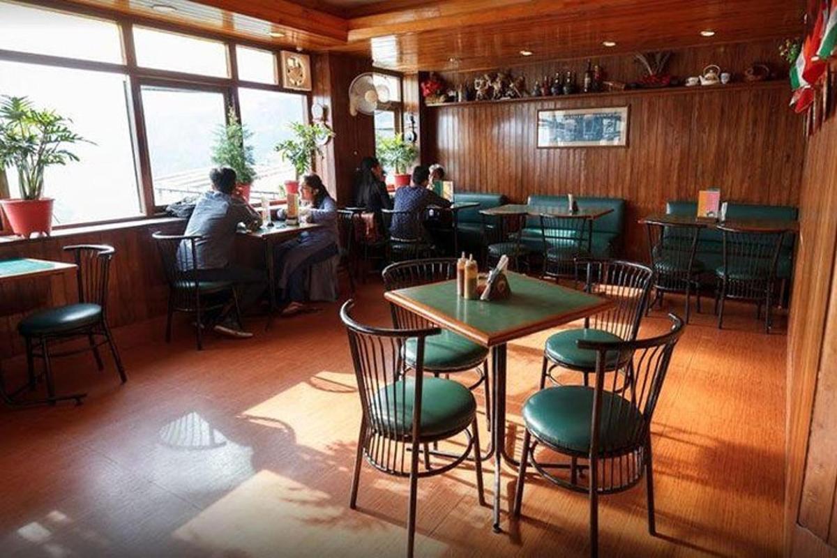 a restaurant with people sitting at tables in a room