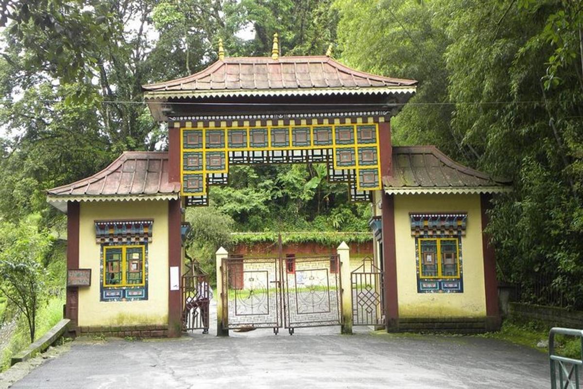 a small building with a gate in a park