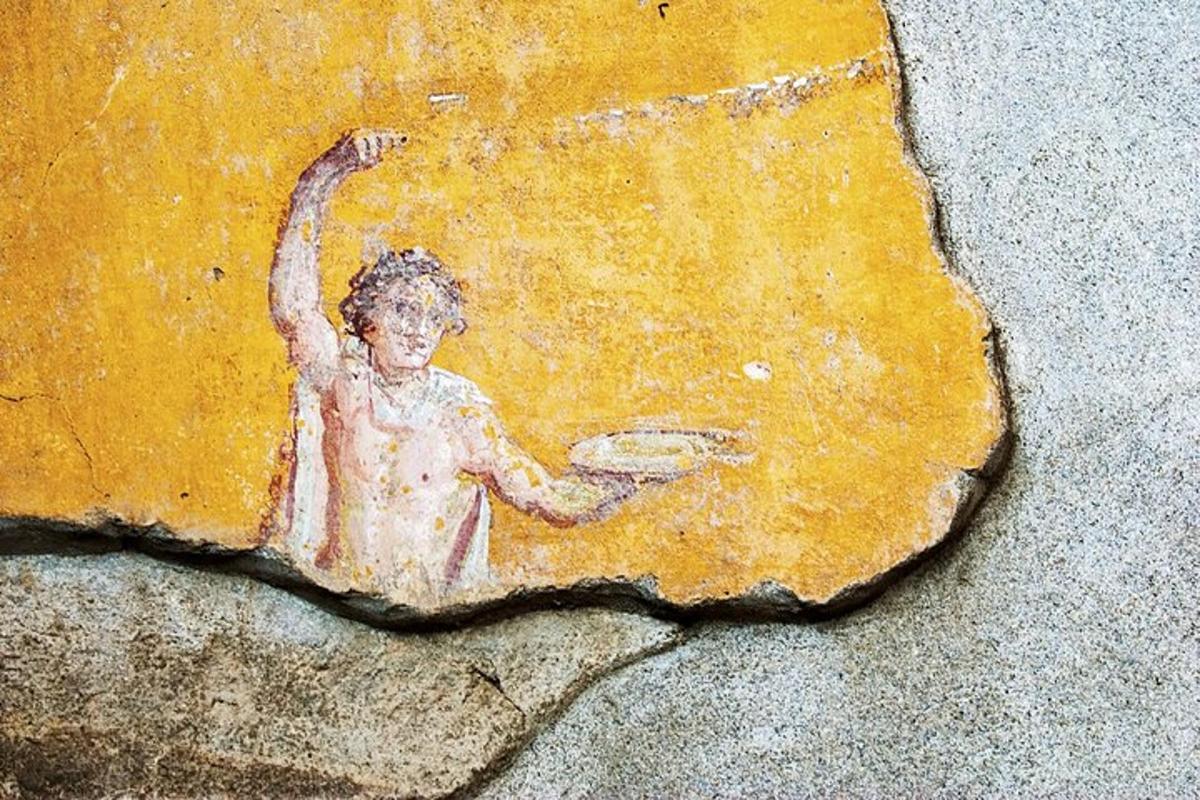 isang painting ng isang bata na may hawak na frisbee sa isang bato