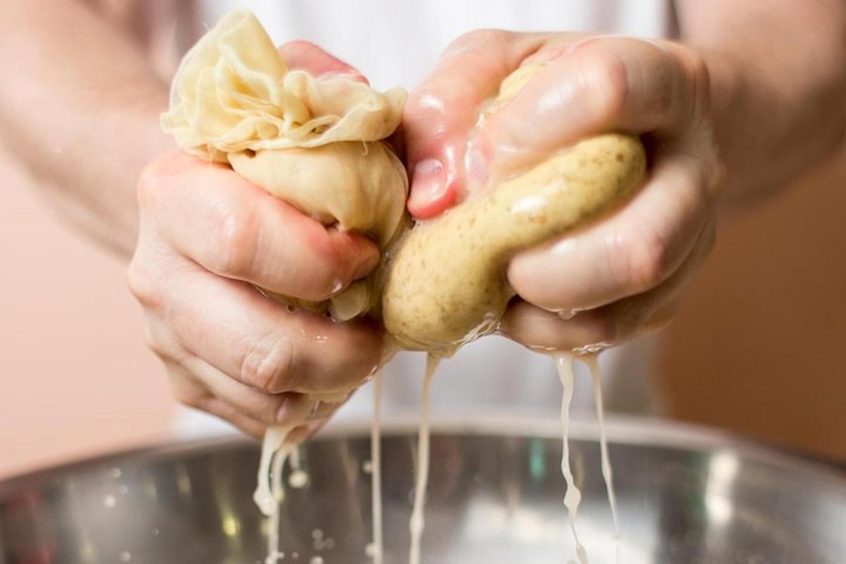 a person is holding a potato in a bowl