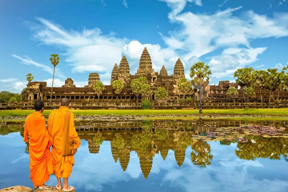 a couple of monks standing in front of a temple
