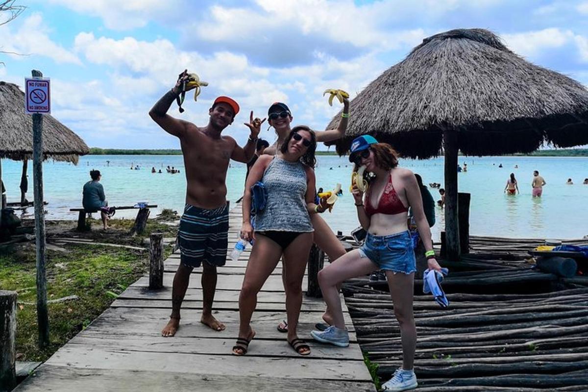 a group of people standing on a dock at the beach