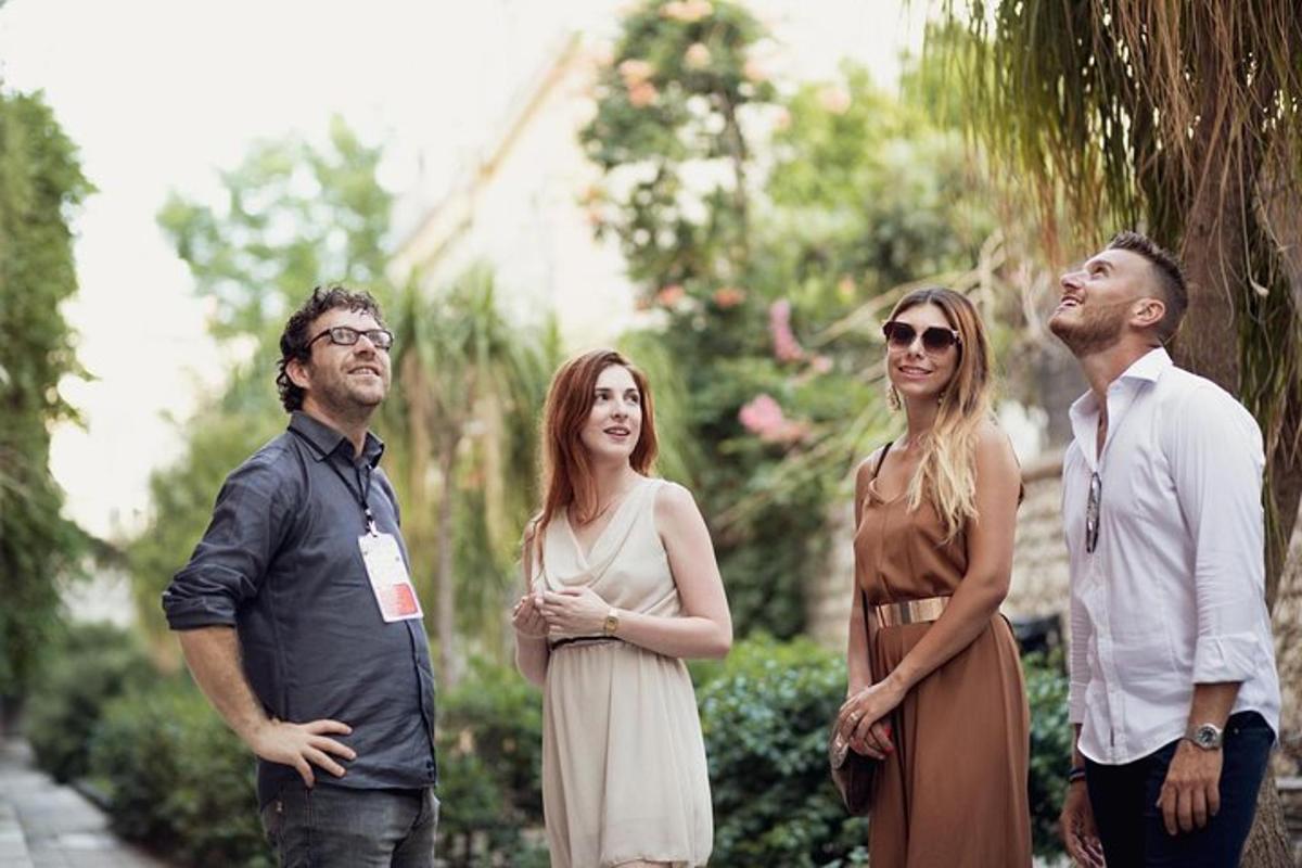 a group of people standing next to a tree