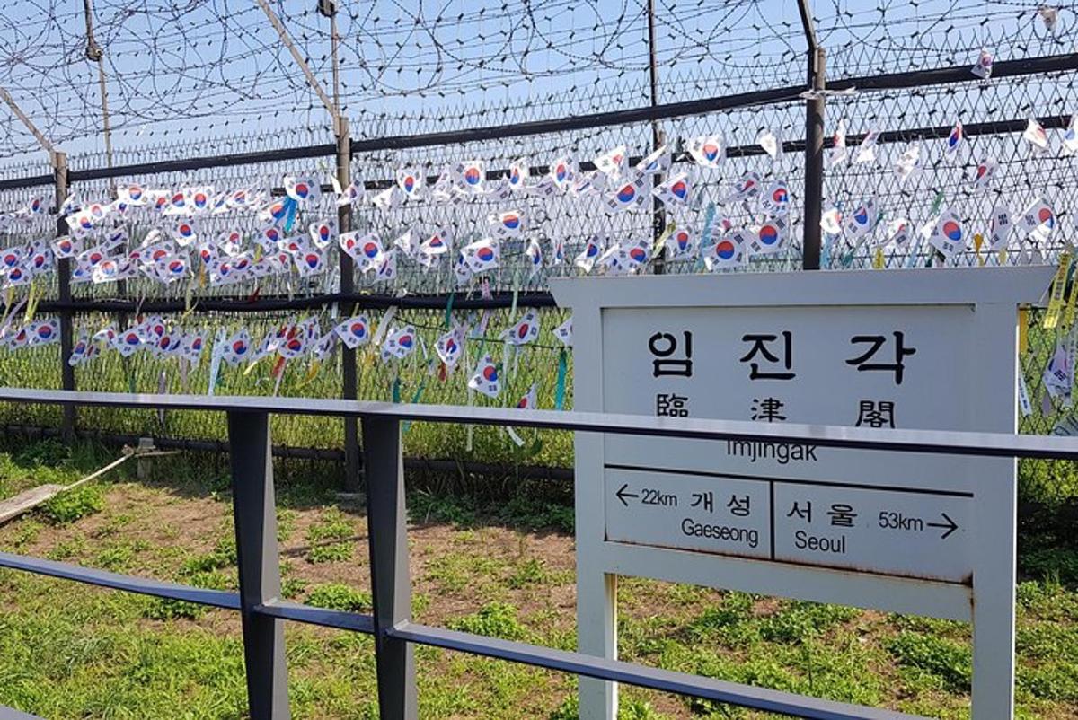 a fence with a bunch of glass bottles on it